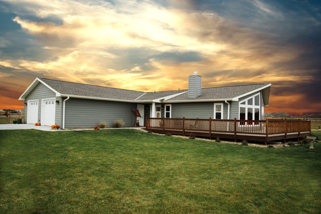 Ponderosa home with gray siding and a wood deck